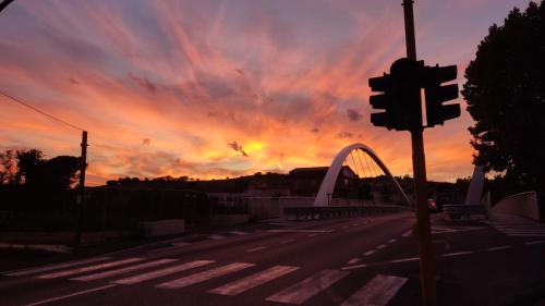 a sunset over a street with a traffic light at Casa Elvezia Guest House in SantʼElpidio a Mare