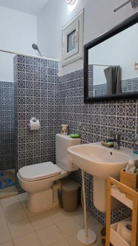 a bathroom with a toilet and a sink and a mirror at Villa Dar La Belle Beyah - Tezdaine in Taguermess
