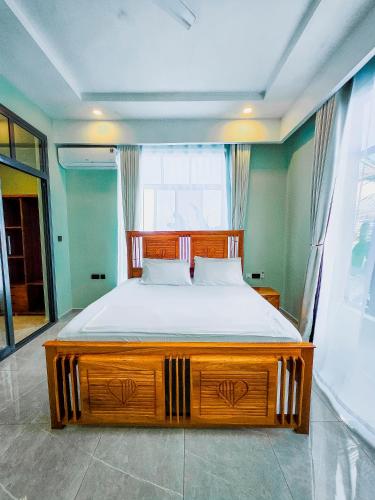 a bedroom with a large wooden bed in a room at Matemwe Bluu Villa in Matemwe