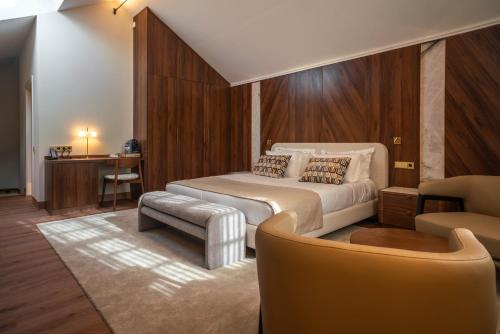 a bedroom with a bed and a couch and a chair at The Book Hotel in Horta