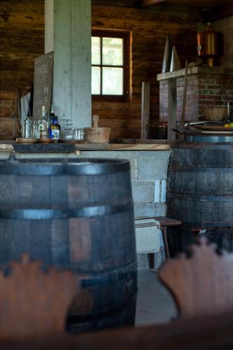 a kitchen with a counter and a table with barrels at Bungalow Volk Turjaški in Gabrovka