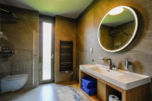 a bathroom with a sink and a mirror at Victory port Apartmán in Liptovský Mikuláš