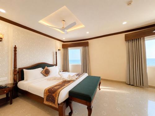 a bedroom with a bed and a large window at Hotel Prabhu Pada Puri - Beach Front Hotel With Swimming Pool And Restaurant - SPA- Banquet - Parking Facility in Puri