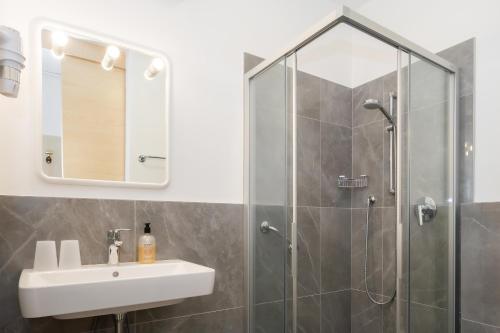 a bathroom with a sink and a shower at Hotel Markushof - Adults only in Auer