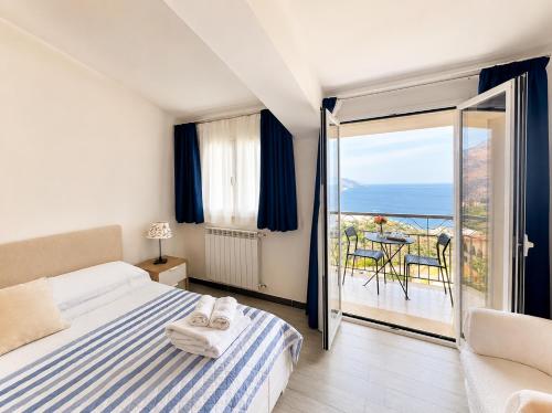 a bedroom with a bed and a view of the ocean at Blue Sky House in Taormina