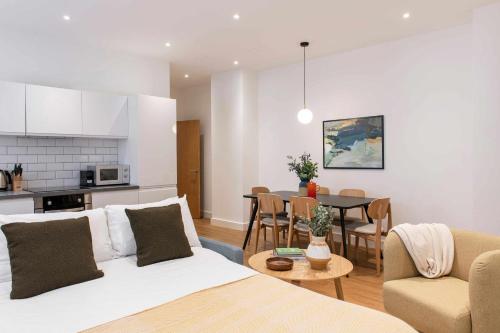 a living room and kitchen with a couch and a table at Cove Minshull Street in Manchester