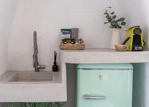 a kitchen with a sink and a blue refrigerator at The Windmill Serifos in Serifos Chora