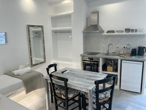 a kitchen with a table and chairs in a room at Ione Inn in Naxos Chora
