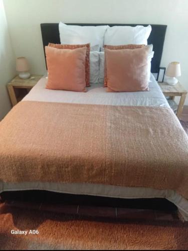 a bed with two pillows on it with at Boschberg Accommodation in Somerset East
