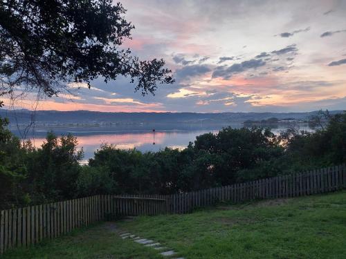 a view of a body of water with a fence at The Glen Getaway in Lake Brenton
