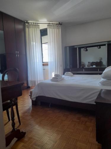 a bedroom with a large bed and a mirror at Diana Apartment Savona in Savona