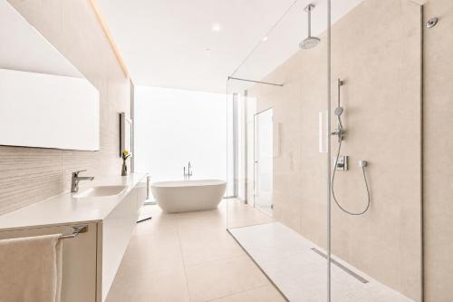 a bathroom with a tub and a sink and a shower at CHALET 95, Lujo y Piscina Infinity in Adeje
