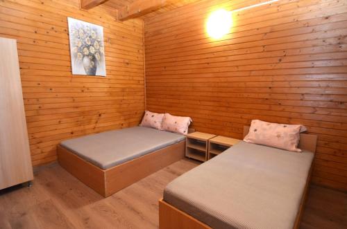 a small room with two beds in a cabin at Vila Flora Costinesti in Costinesti