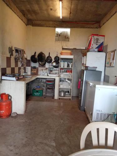 a kitchen with a refrigerator and a counter top at Mamima BnB in Caramoan