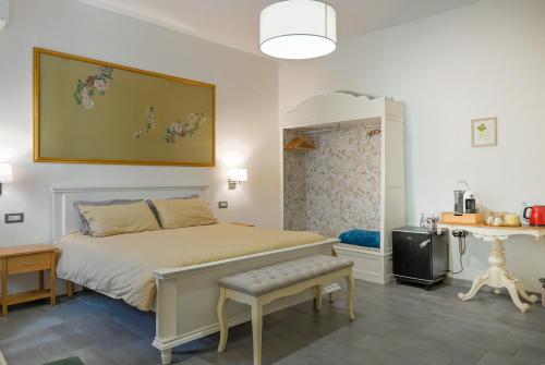 a bedroom with a bed and a table and a desk at Cozy guest house Downtown in Olbia