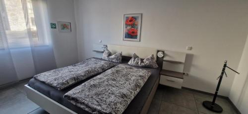 a bedroom with two beds and a lamp in it at VivaNatura Eifelferienappartement in Simmerath