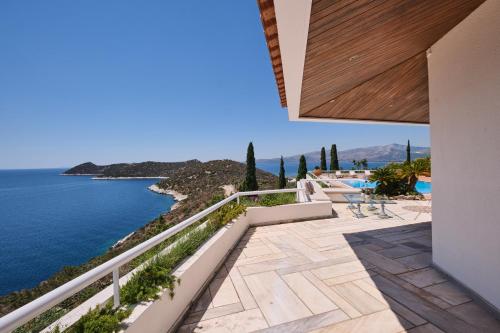 a view from the balcony of a house overlooking the water at Villa Artisti Marathon in Marathon