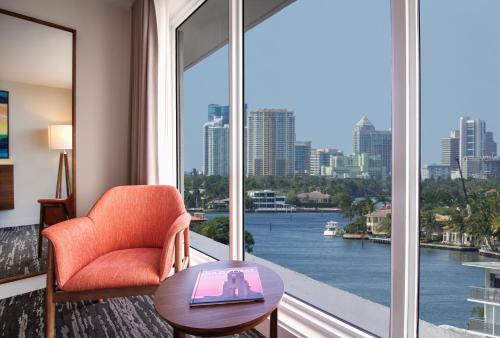 a room with a chair and a window with a view at B Ocean Resort Fort Lauderdale Beach in Fort Lauderdale