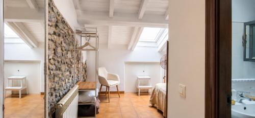 a room with a bed and a bathroom with a sink at El Juacu in Llanes