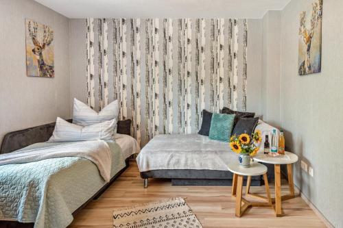 a bedroom with a bed and a couch and a table at Weinbergschnecke Ferienwohnung in Efringen-Kirchen