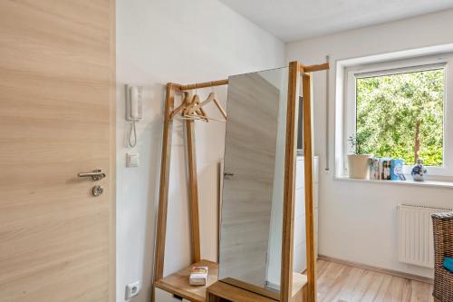 a bathroom with a mirror next to a window at Weinbergschnecke Ferienwohnung in Efringen-Kirchen