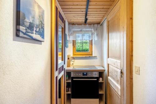 a small kitchen with a sink and a stove at Haus Elfriede Schmid in Bad Bayersoien