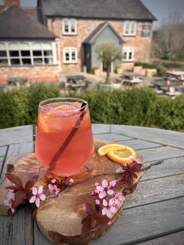 a drink sitting on top of a wooden table at The Baiting House in Upper Sapey