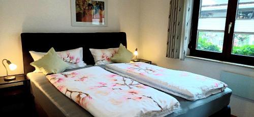 a bedroom with a bed with flowers on it at Ferienhaus am Blumengässle in Feldberg