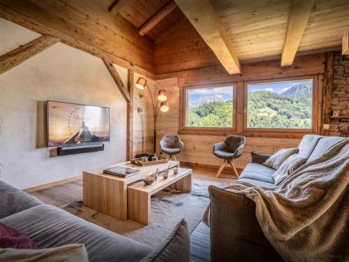 a living room with a couch and a table at Lodge La Source - OVO Network in Les Clefs