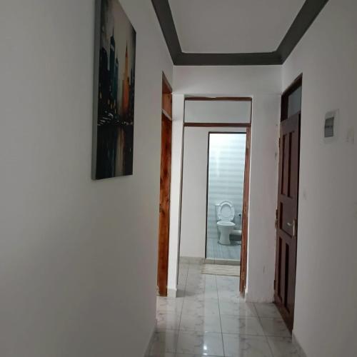 a hallway with a bathroom with a toilet in it at MahaliaLuxuryStays in Malindi