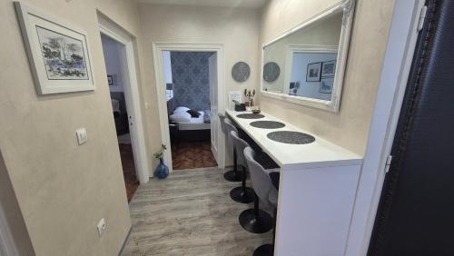a bathroom with a sink and a mirror at Deluxe Zoya Centar in Pula