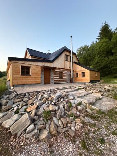 a house on a hill with a pile of rocks at Bouda Ticha in Dolní Malá Úpa