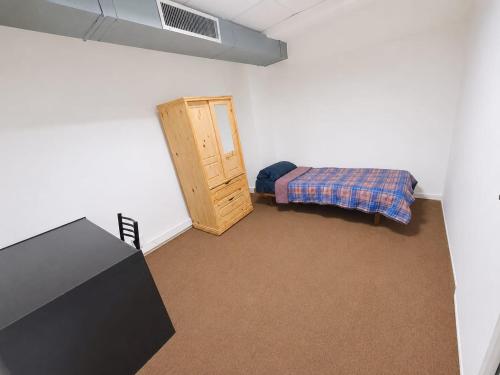 a small room with a bed and a small cabinet at Estudio Residencias in Buenos Aires