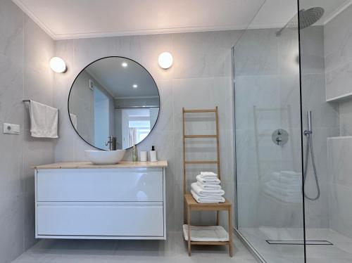 a bathroom with a sink and a mirror at UpTown Apartments in Horta