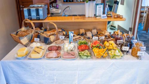 a table filled with different types of fruits and vegetables at Arnanes Country Hotel in Höfn
