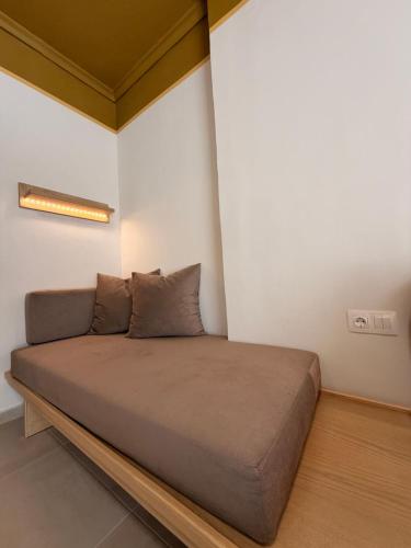 a large bed in a room with a wall at Aurora Suite in Xanthi