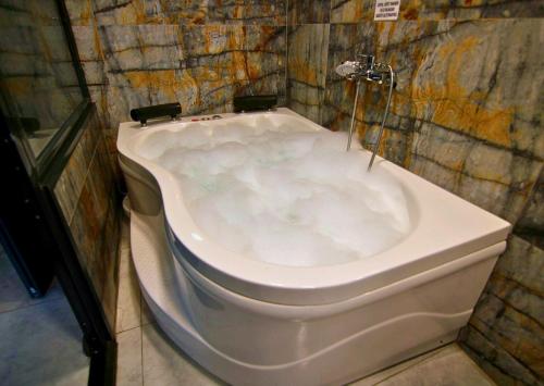 a bath tub in a bathroom with a toilet at 216 Eagle Palace Suite in Istanbul