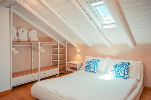 a bedroom with a white bed and a skylight at Villa Mastrissa Taormina - Private Villa with 2 pool in Taormina