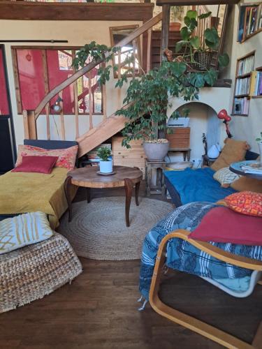 a room with two beds and a table at chambre à la campagne in Saint-Mathieu