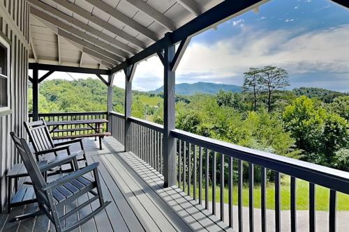 a porch with chairs and a view of the mountains at Bluff Mountain Vista in Sevierville