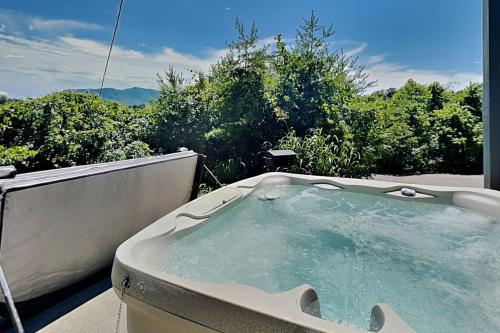 a jacuzzi tub sitting on top of a balcony at Bluff Mountain Vista in Sevierville