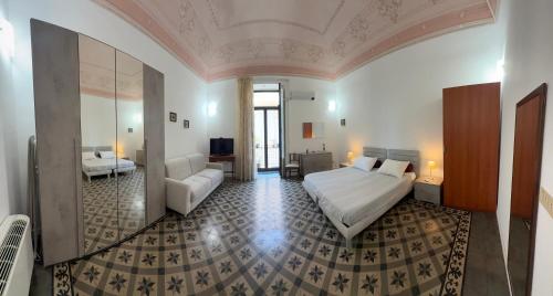 a bedroom with a bed and a couch in a room at Crispi Accomodation B&B in Catania