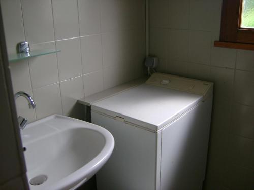 a small bathroom with a sink and a refrigerator at Tastet in MouscardÃ¨s