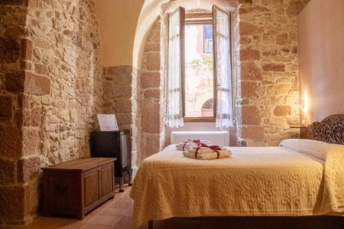 a bedroom with a bed and a window at S'Asilo Boutique B&B - North Sardinia - Village stay in Banari