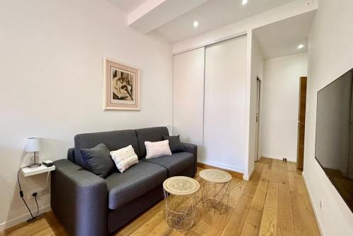 a living room with a couch and two tables at Casamea - Studio, Terrasse, Clim, Centre hist in Ajaccio