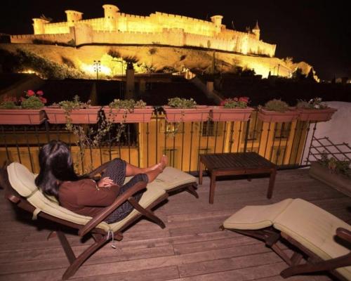a woman laying on a lounge chair in front of access at Les florentines in Carcassonne