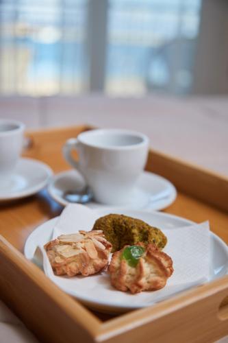 a plate of food and a cup of coffee on a table at La Zagara Rooms - Porto di Milazzo in Milazzo