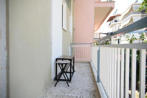 a stool sitting on the balcony of a building at ChaKo Stay Solutions Studio in Lamía