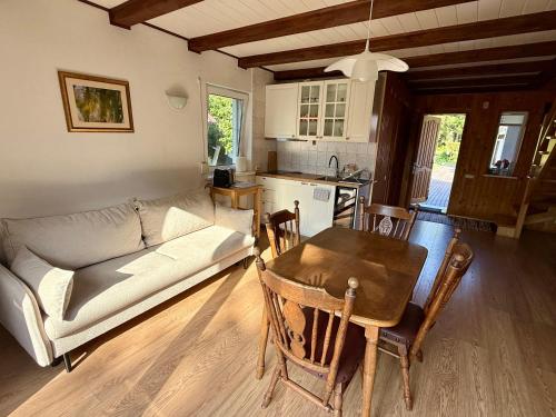 a living room with a couch and a table and a kitchen at Juka in Palanga
