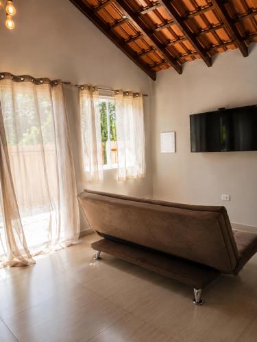 a large couch in a room with windows at Canto Sereno Refúgio entre Praias e Ilhas in Paraty